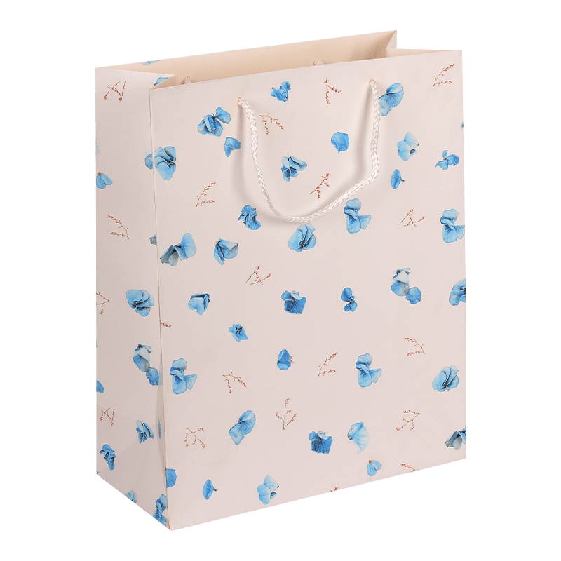 Bolsa de regalo de papel con estampado floral y asa